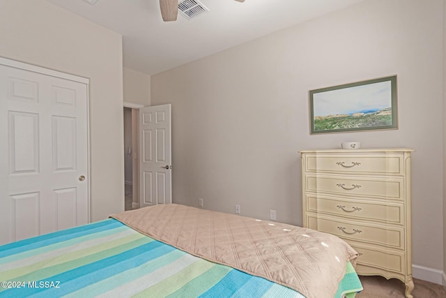 carpeted bedroom featuring baseboards, visible vents, and a ceiling fan