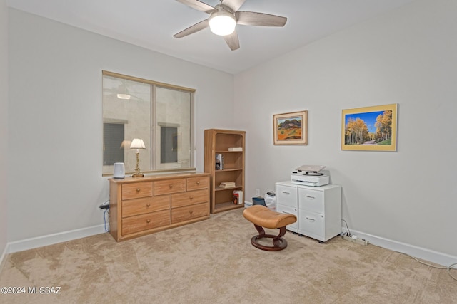 interior space featuring light carpet, ceiling fan, and baseboards