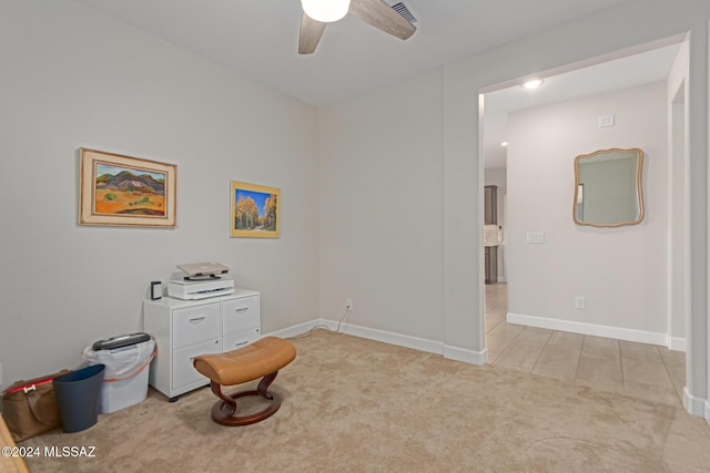 sitting room featuring a ceiling fan, light carpet, and baseboards