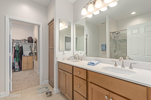 bathroom featuring walk in shower, vanity, and tile patterned floors