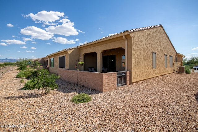 view of side of property with central air condition unit