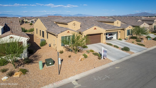 view of front of home featuring a mountain view and a garage