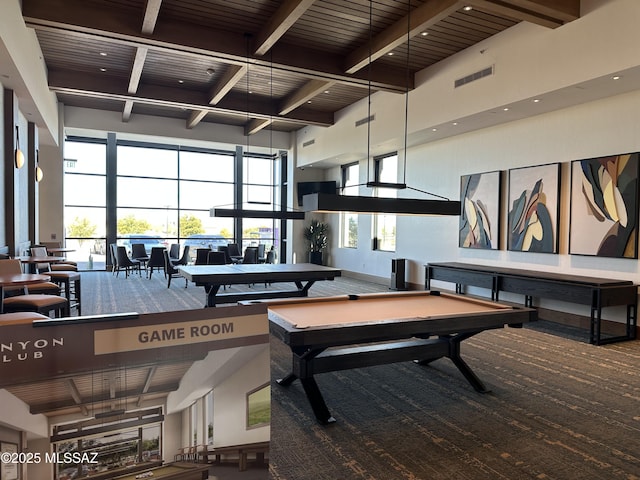 game room with visible vents, a high ceiling, carpet flooring, and beam ceiling