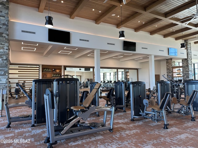 workout area with a towering ceiling, wood ceiling, and visible vents