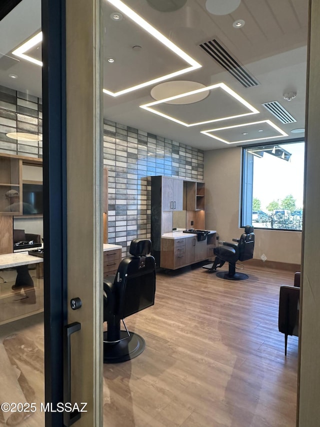 office featuring visible vents and wood finished floors