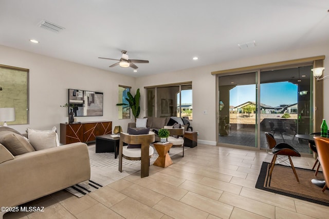 living area with recessed lighting, visible vents, and a ceiling fan