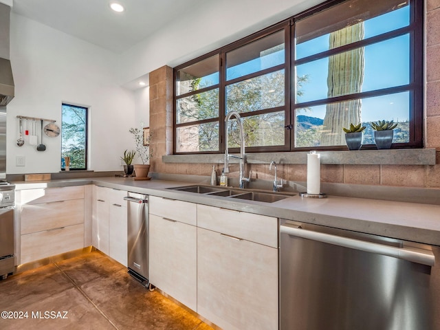 kitchen with stainless steel dishwasher, concrete flooring, light countertops, white cabinetry, and recessed lighting