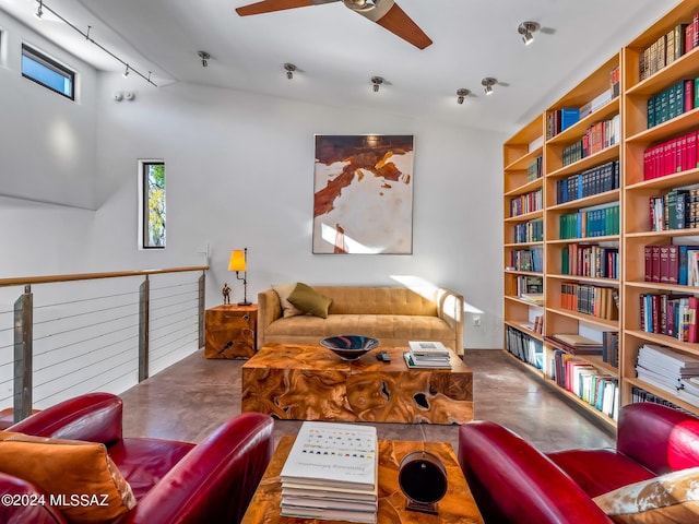 living room with concrete floors, lofted ceiling, a ceiling fan, and track lighting