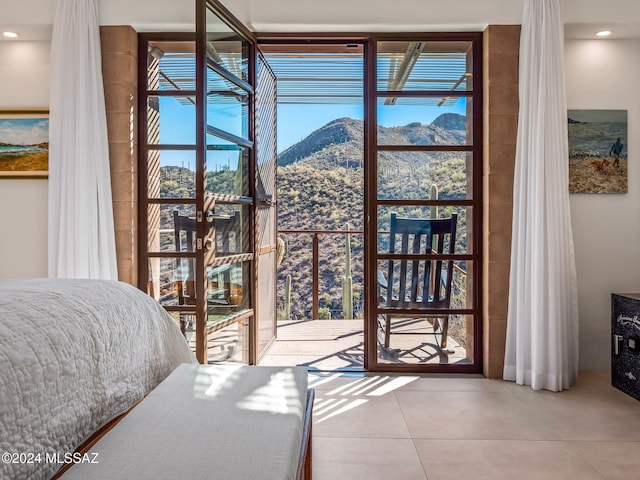 bedroom with a mountain view and tile patterned floors