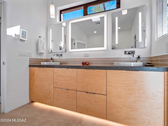 bathroom featuring tile patterned flooring, vanity, and a healthy amount of sunlight