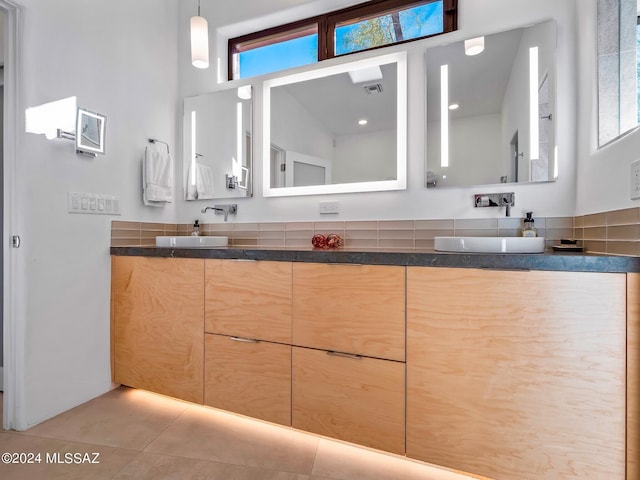 full bath with double vanity and tile patterned flooring