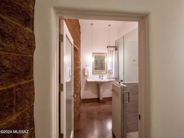 bathroom featuring concrete floors and an enclosed shower