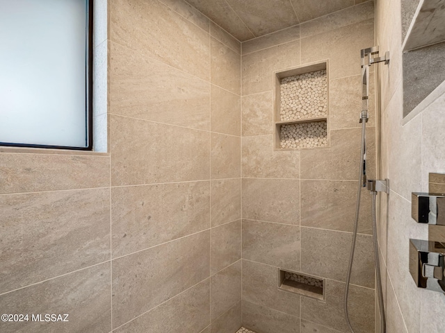 full bathroom with tiled shower