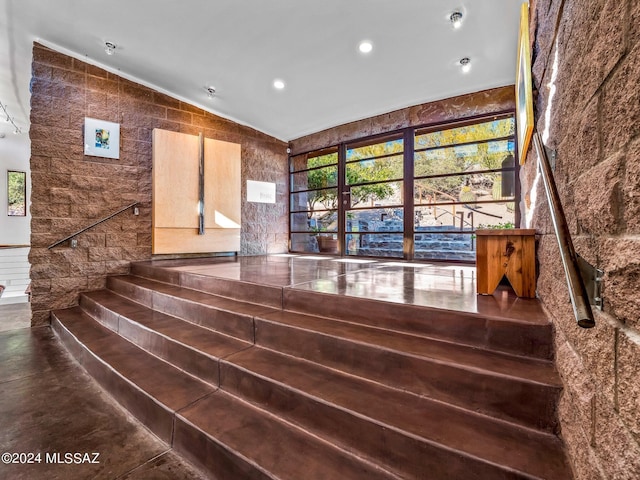 staircase featuring lofted ceiling and recessed lighting