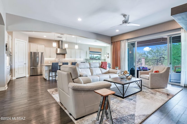 living room with ceiling fan and dark hardwood / wood-style floors