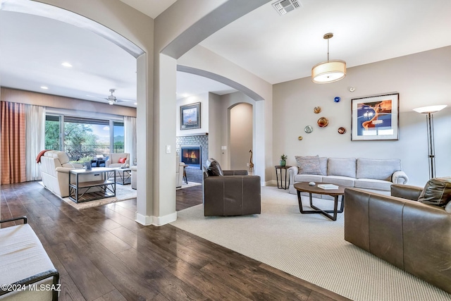 living room with ceiling fan and dark hardwood / wood-style flooring