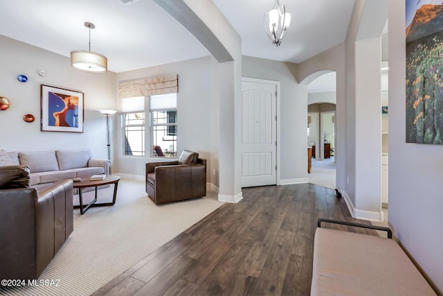 living room featuring dark hardwood / wood-style floors and a chandelier