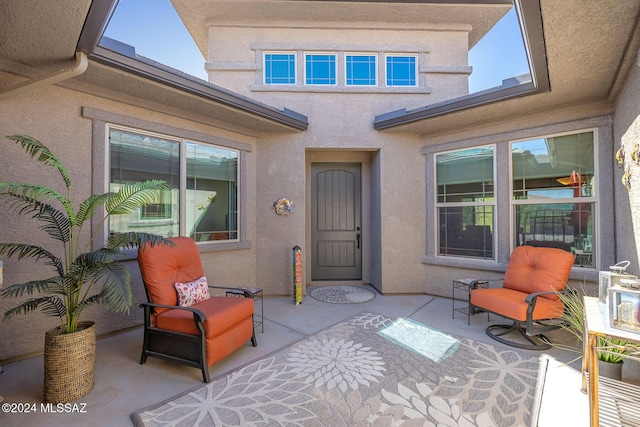 entrance to property featuring a patio area