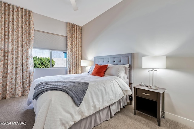 bedroom with light carpet, ceiling fan, and lofted ceiling