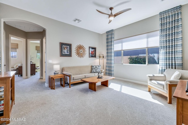 carpeted living room featuring ceiling fan