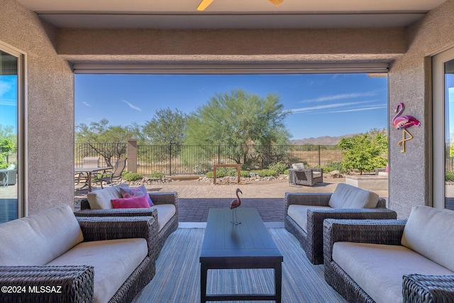 view of patio with outdoor lounge area and ceiling fan