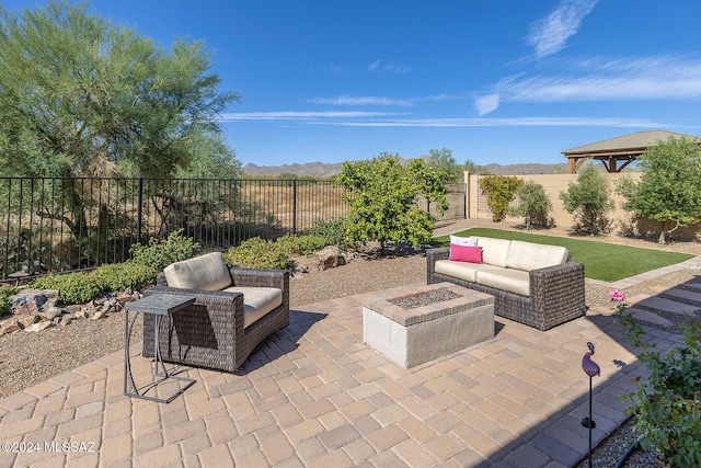 view of patio featuring a mountain view and an outdoor fire pit