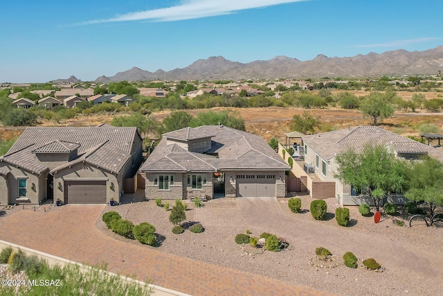 view of front of property with a mountain view and a garage