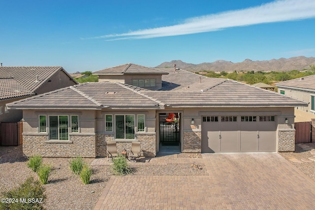 prairie-style house with a mountain view and a garage