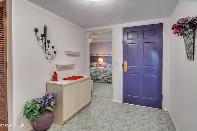 entryway with a textured ceiling