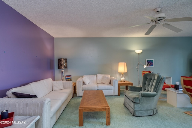 living room with a textured ceiling, ceiling fan, and carpet floors