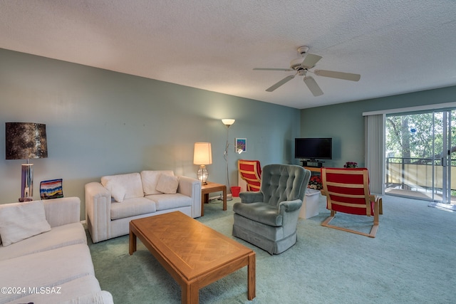 living room with a textured ceiling, carpet, and ceiling fan