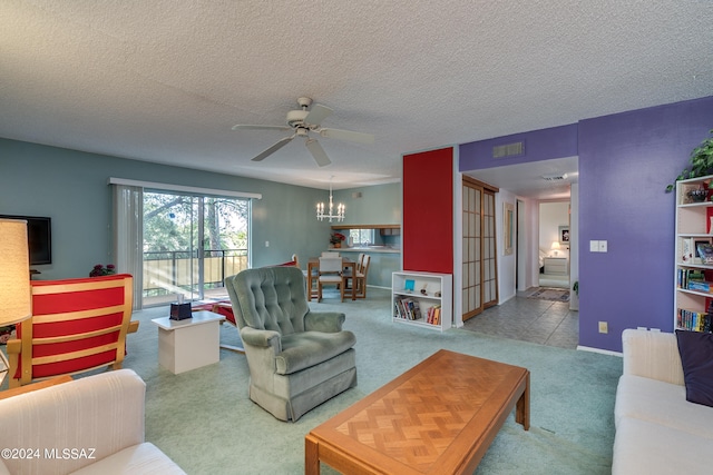 living room with carpet floors, a textured ceiling, and ceiling fan with notable chandelier