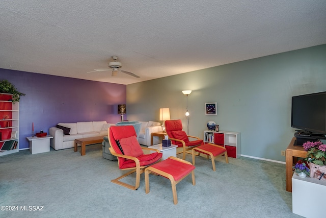 carpeted living room with ceiling fan and a textured ceiling