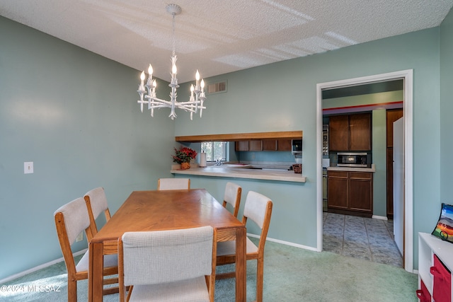 carpeted dining space with a textured ceiling and an inviting chandelier