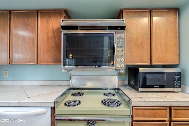 kitchen with tile counters and range with electric cooktop