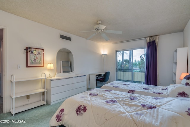 bedroom featuring a textured ceiling, carpet floors, and ceiling fan