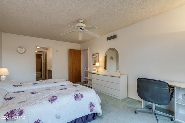 bedroom featuring ceiling fan, a textured ceiling, and light colored carpet