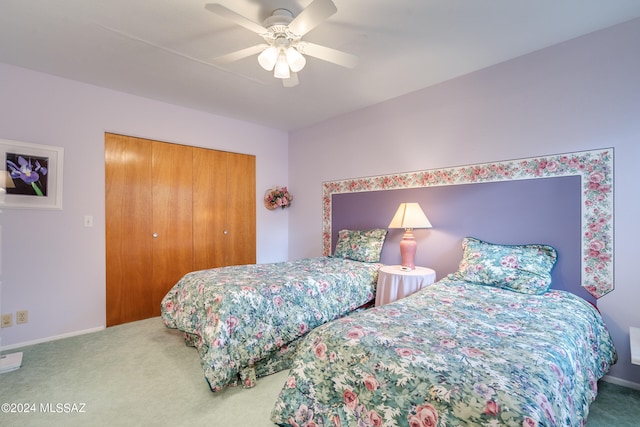 carpeted bedroom featuring a closet and ceiling fan