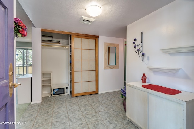 laundry room featuring a textured ceiling