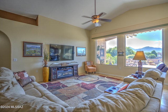 living room featuring ceiling fan and vaulted ceiling