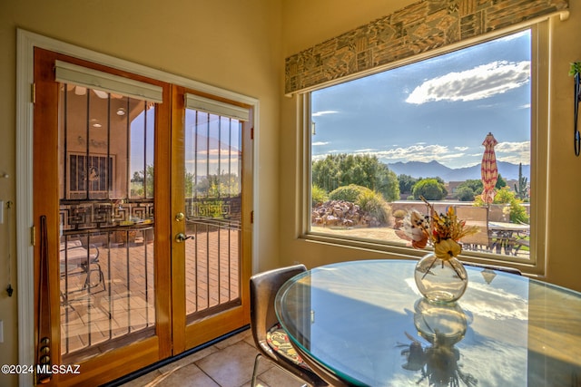 sunroom featuring a mountain view and french doors