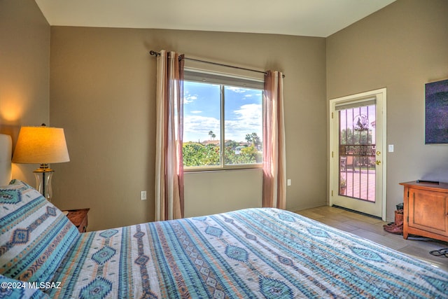 bedroom with lofted ceiling, access to exterior, and light hardwood / wood-style flooring