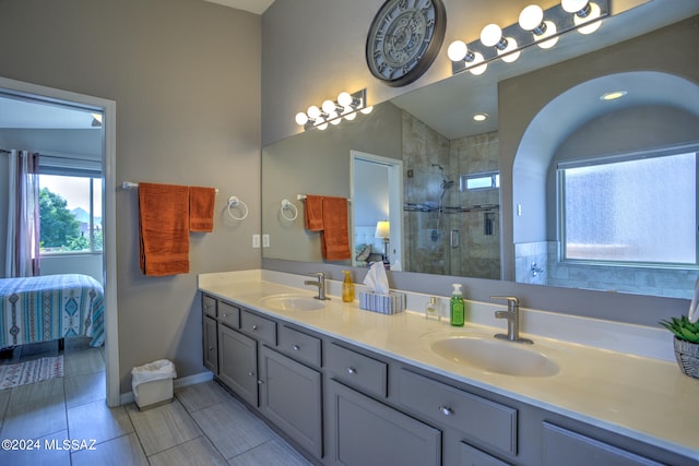 bathroom with vanity, a shower with door, and tile patterned floors