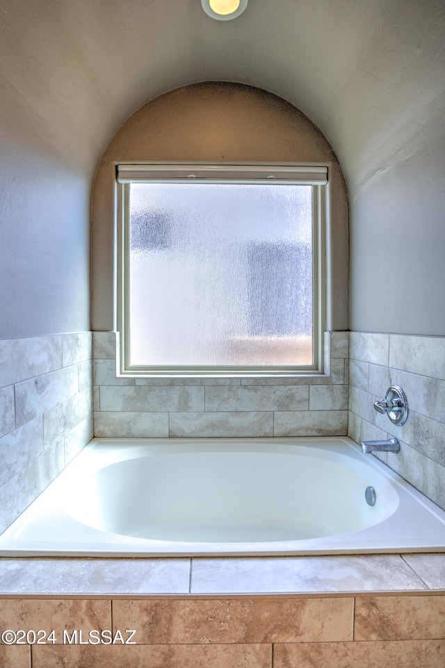 bathroom featuring a relaxing tiled tub