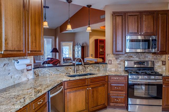 kitchen with sink, hanging light fixtures, vaulted ceiling, decorative backsplash, and stainless steel appliances