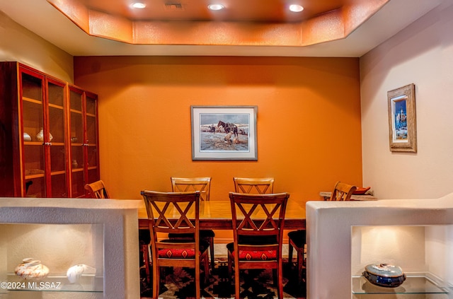 dining space featuring a raised ceiling