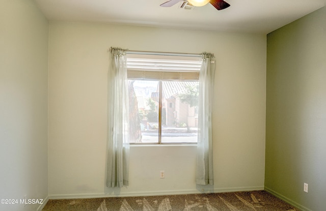 carpeted empty room featuring ceiling fan