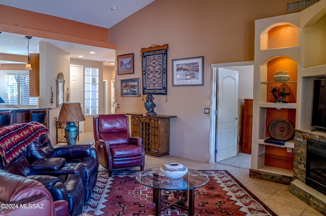 tiled living room with built in shelves and a fireplace