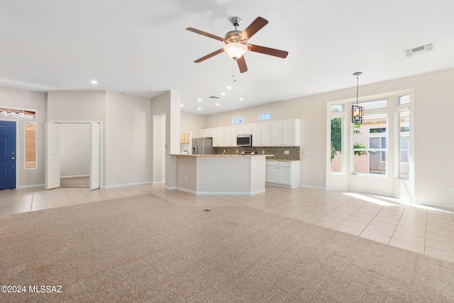 unfurnished living room featuring light colored carpet and ceiling fan