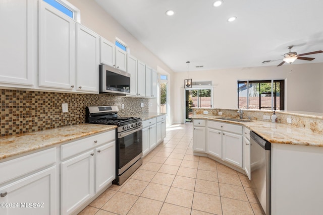 kitchen featuring stainless steel appliances, ceiling fan, sink, white cabinetry, and hanging light fixtures